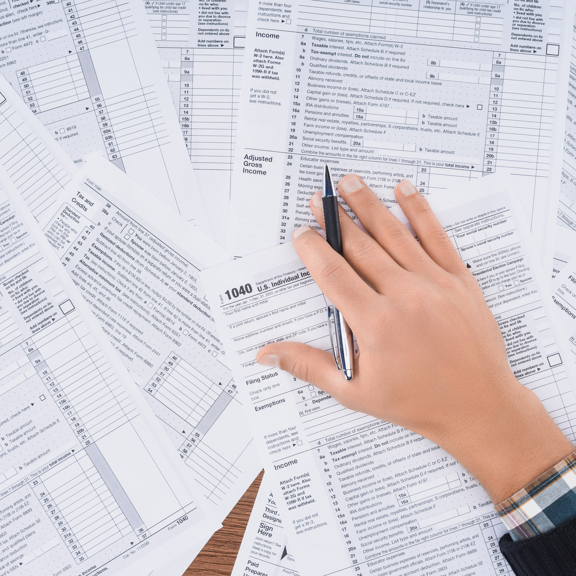 29460783 Cropped View Of Man Holding Pen And Filling Tax Forms (1)